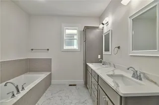 Pictures are of the actual home. Master bath features a soaker tub, dual vanities, plus a tower cabinet for storage. Beautiful hexagon tile for the flooring and quartz counters.