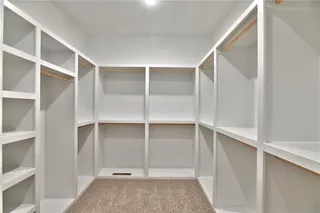 Pictures are of the actual home. Spacious  master closet with great storage organization.