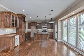 Spacious kitchen with so much cabinet space.  Includes wine storage, an island, and breakfast bar, with granite counter tops.