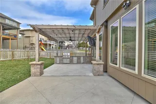 Back patio with pergola and gorgeous outdoor kitchen.  So many parties in your future!