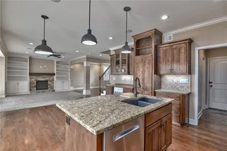 Large kitchen island with a breakfast bar, granite counter tops, and stainless appliances.  Completely open to the living area, perfect for entertaining all of your guests!