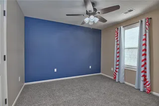 Bedroom 3 has a ceiling fan and an accent wall.