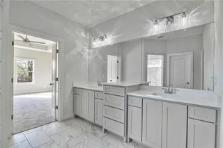 Pictures are of a Previous Model AND MAY FEATURE UPGRADES. SEVERAL BUYER SELECTIONS ARE STILL AVAILABLE. PLEASE CONTACT LISTING AGENT FOR DETAILS.Master Bathroom featuring double sink vanity, and tile flooring