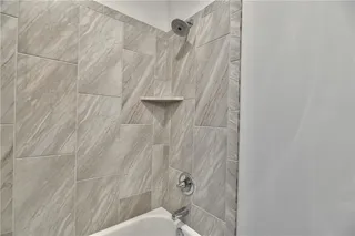 Pictures are of a Previous Model AND MAY FEATURE UPGRADES. SEVERAL BUYER SELECTIONS ARE STILL AVAILABLE. PLEASE CONTACT LISTING AGENT FOR DETAILS.Bathroom #2 featuring tiled shower / bath combo