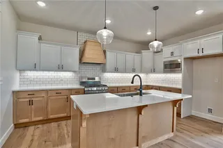 View into Kitchen. Soft Closed Cabinets and Drawers. Quartz Counter Tops, Gas Cook Top, Vent Hood, Stainless Steel Appliances, Super Single Stainless Steel Sink and Wider Plank Hardwood Floors. So Many Upgrades! Picture is of Actual Home.