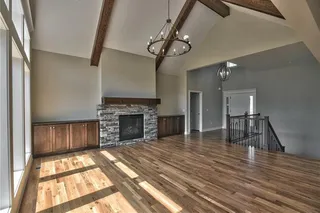 The Sonoma Reverse -Pictures are Not of Actual Home - View from Dining Room into Great Room with Vaulted Beamed Ceiling, Fireplace and Built-in Cabinets