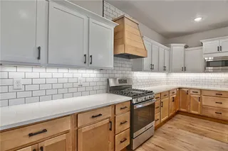 View into Kitchen. Soft Closed Cabinets and Drawers. Quartz Counter Tops, Gas Cook Top, Vent Hood, Stainless Steel Appliances, Super Single Stainless Steel Sink and Wider Plank Hardwood Floors. So Many Upgrades! Picture is of Actual Home. 