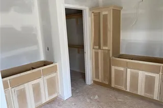 Primary Bathroom with separate vanities and storage cabinet.