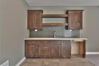 The Sonoma Reverse -Pictures are Not of Actual Home- Lower Level Bar with Upper and Lower Cabinets and Upgraded Herringbone Tile Backsplash