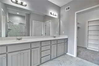 Master Bathroom with Walk in Shower, Tiled Floor & Shower and Double Vanity. Picture is of Actual Home.