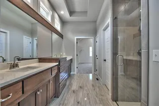 The Sonoma Reverse - Master Bathroom with Upgraded Polished Tile, Dual Vanities and Zero Entry Shower with Dual Shower Heads