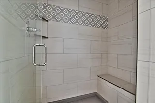 Master Bath Walk In Shower with Bench Seat, Decorative Tile and Tile to the Ceiling. Picture is of Actual Home. 
