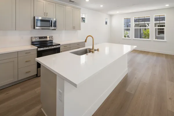 Kitchen with center island, stainless steel appliances and open great room.