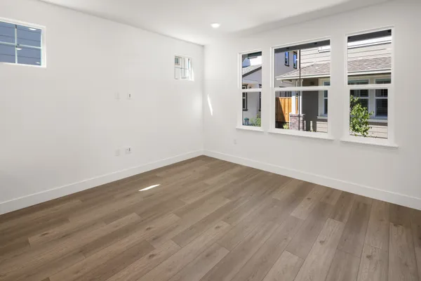 Bright great room with large windows and luxury vinyl plank flooring.