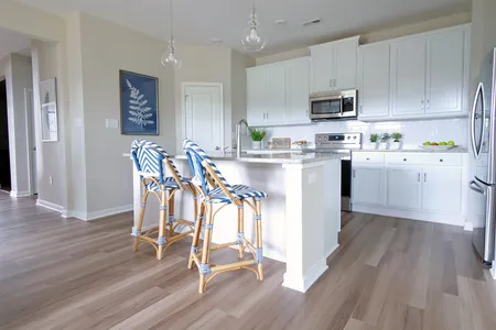 Kitchen with island sink and seating at The Villas at Iron Mill: Shenandoah