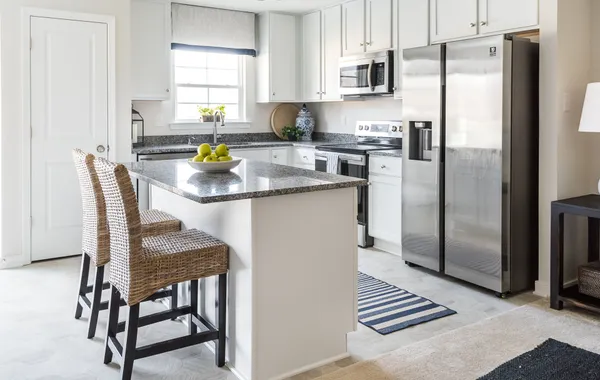 Kitchen with island seating at The Village at Millers Lane: Raleigh