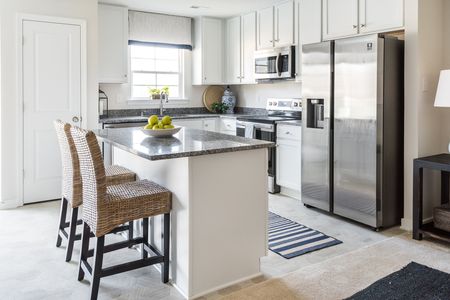 Kitchen with island seating at The Village at Millers Lane: Raleigh