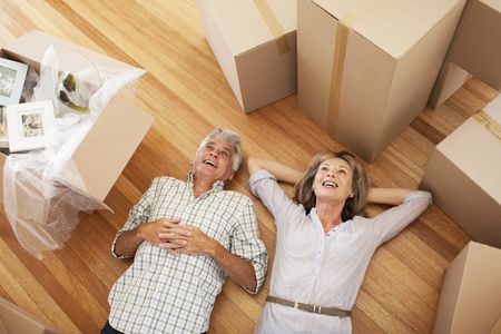 55+ Couple Moving into New Home with Moving Boxes