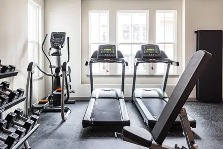 Interior gym photo with treadmills, weights, and elliptical