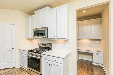 Kitchen with stainless steel appliances at Townes at Notting Place: Oak