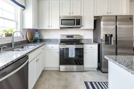 Kitchen with stainless steel appliances at The Village at Millers Lane: Raleigh