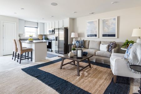 Living room area and adjacent kitchen at The Village at Millers Lane: Raleigh
