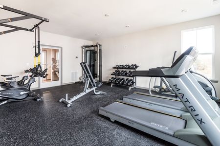 Interior gym photo with treadmills, weights, elliptical, stationary bikes, and more