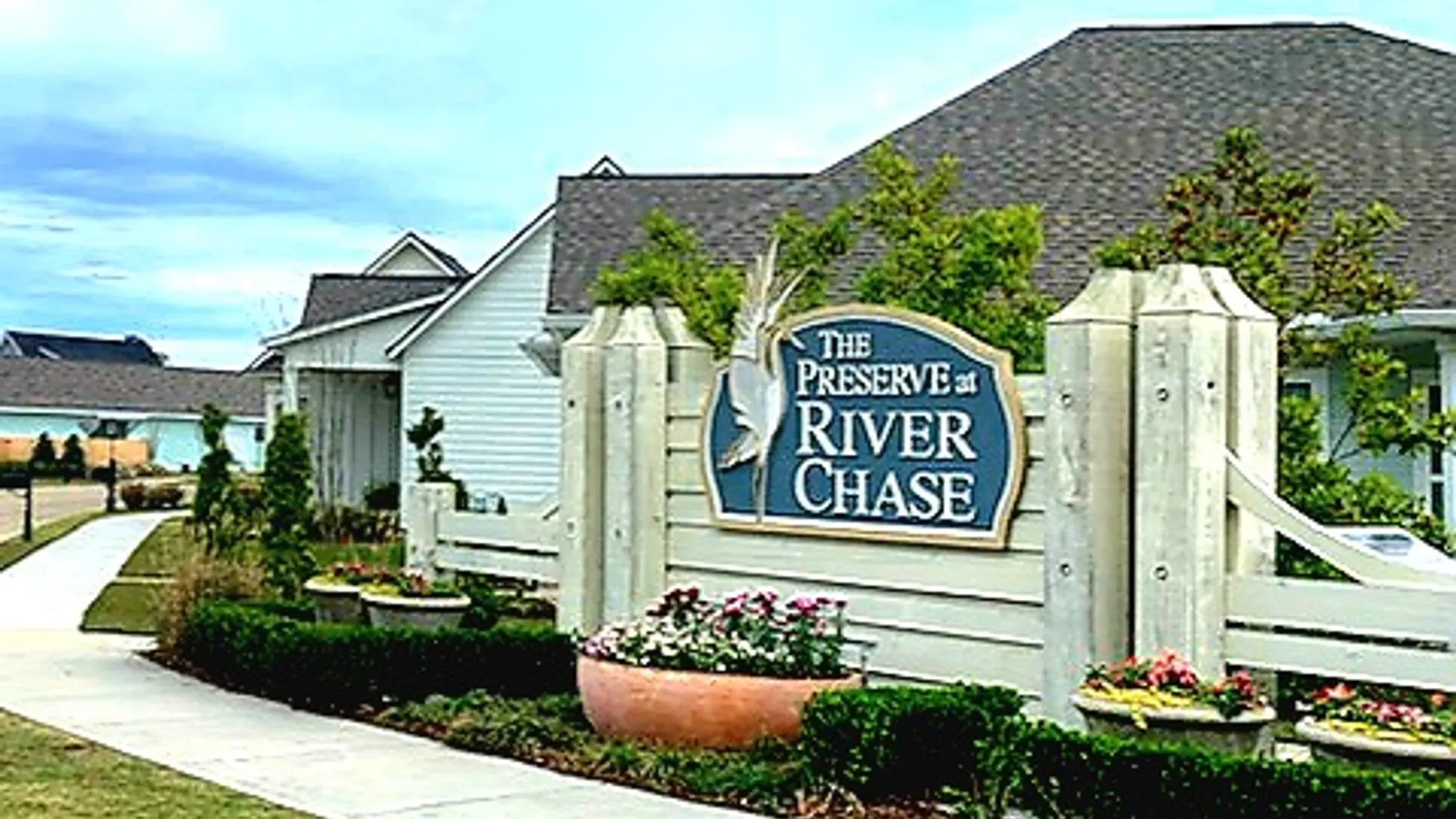 entrance of a new home community - the preserve at river chase by sunrise homes