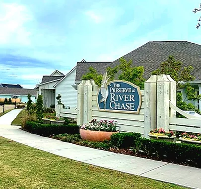 entrance of a new home community - the preserve at river chase by sunrise homes