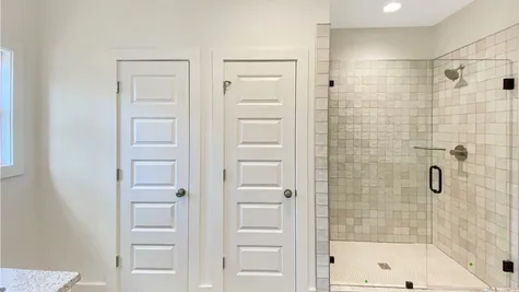 Water closet, linen closet, tile shower