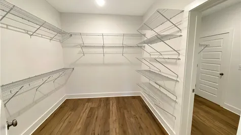 walk-in closet connected to laundry room