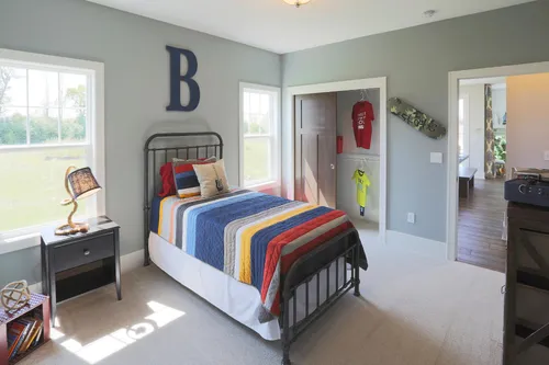 Blue-gray bedroom on main level by Tim O'Brien Homes