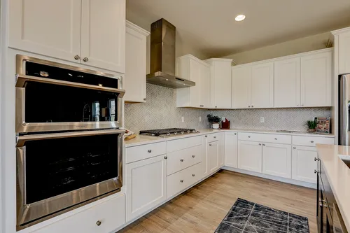 White kitchen with herringbone backsplash in a new house