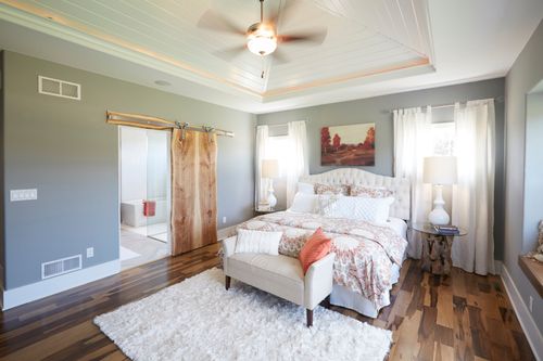 Master suite with barn doors by home builders in Milwaukee