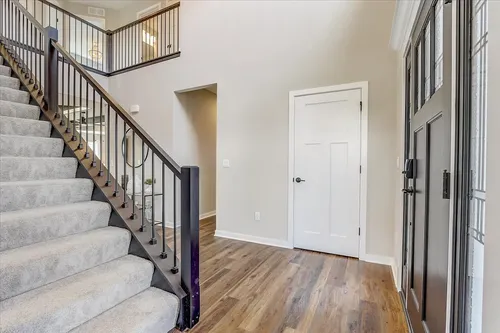 staircase in the entryway of a new home in oregon wi by tim o'brien homes