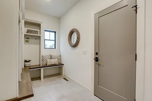 Neutral mudroom in a new home by Tim O'Brien