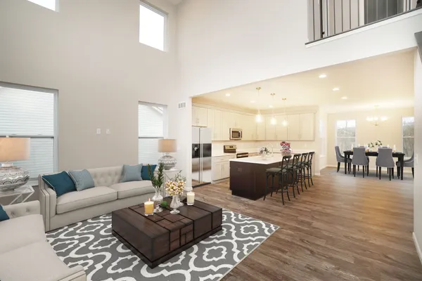 Open Concept Floor Plan with a 2 Story Great Room Featuring a Wall of Windows Filling this Home with Natural Light. The 2 Story Great Room Flows into the High-End Kitchen