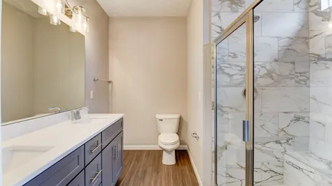 Stunning Bath has Quartz Topped Double Vanity, Moen Fixtures & 5ft x 4ft Walk-In Shower with a Bathing Bench