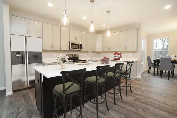 State of the Art Kitchen with 8ft Island, Pendant Lights, Granite Countertops, Soft Close Shaker Cabinetry, Recessed lights & Stainless-Steel Appliances.