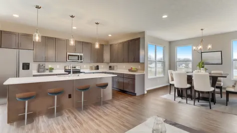 The High-End, Upgraded Kitchen Includes a 9ft Island, Quartz Countertops, 42" & Stainless-Steel Appliances.