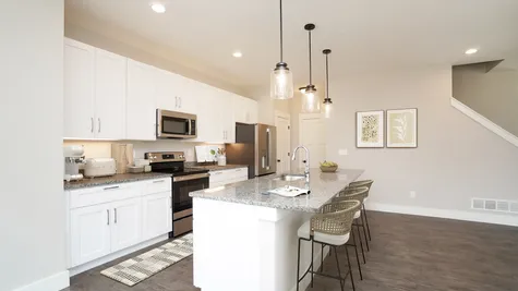 Pendant Lights Above the Island, Granite Countertops & Stainless Steel Appliances Are STANDARD in a Todd Home