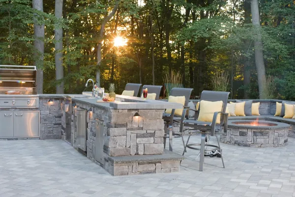 backyard with an outdoor kitchen by delarare home builder