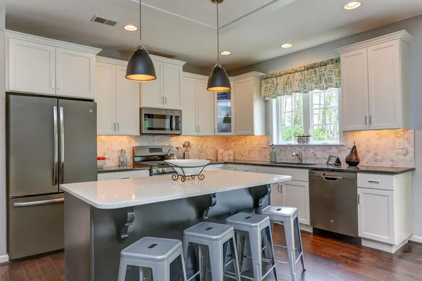 kitchen with an island by home builder in delaware, wilkinson homes