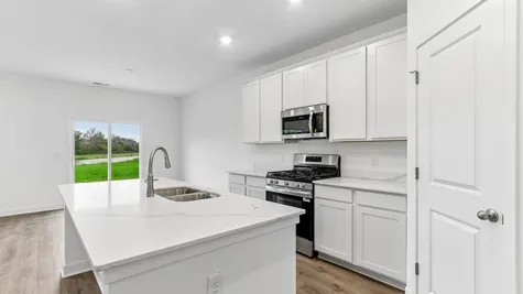 Kitchen with white cabinets and quartz countertops, Abbey Commons