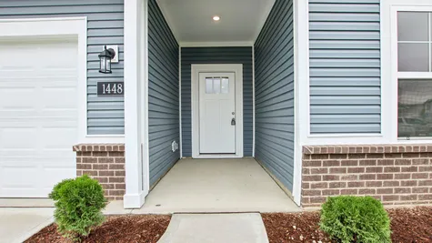 Chestnut by Arbor Homes exterior with blue siding and brick
