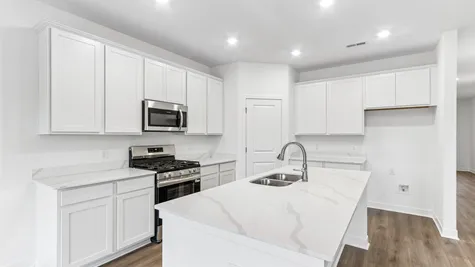 Kitchen with white cabinets and quartz countertops, Abbey Commons