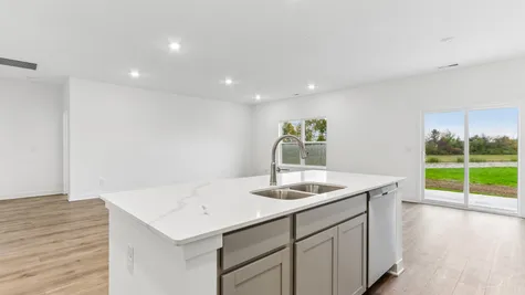 Kitchen island with white cabinets and quartz countertops, Abbey Commons