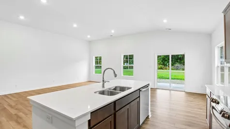 Kitchen of the Chestnut by Arbor Homes with Arid cabinets and a center island
