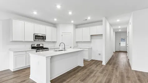 Kitchen with white cabinets and quartz countertops, Abbey Commons