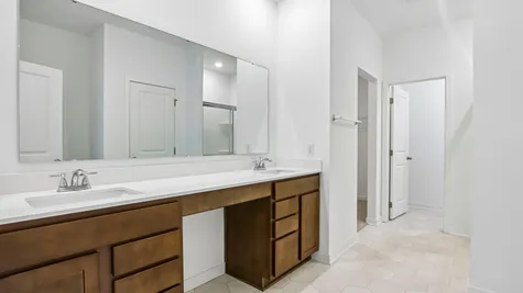 Dual sink vanity in the primary bathroom of the Chestnut by Arbor Homes
